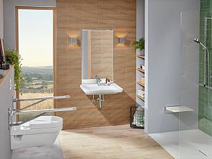 Eine bodengleiche Dusche, seitliche Haltegriffe neben der Toilette und ein Duschklappsitz sorgen für Komfort.